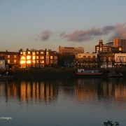 London River Thames, Hammersmith, evening light on the riverside with reflections.