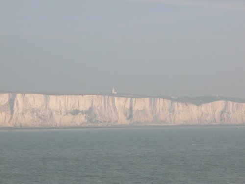 Misty View of the white cliffs of Dover with
the Lighthouse in the background