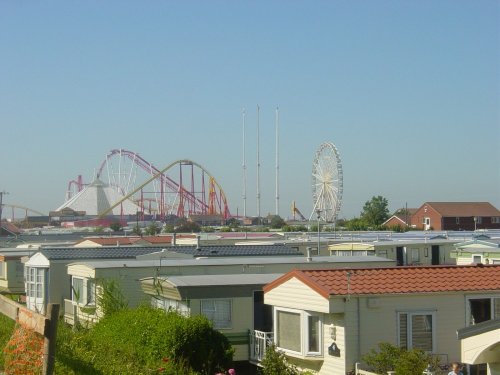 A view of Fantasy Island overlooking Caravan roof tops in the morning sun at 8:47AM, Ingoldmells