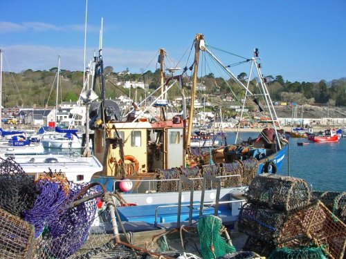 A trawler making ready to go to sea, from the Cobb harbour at Lyme Regis, Dorset.