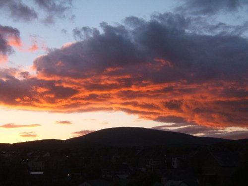 Colourful sunset at Millom, silhouette of Black Combe.