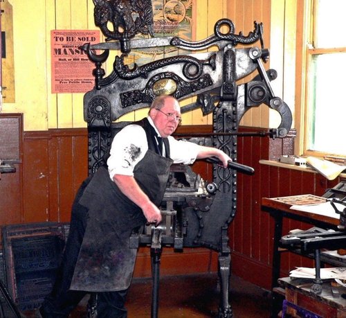 Printer at work in early 20th century dress , Beamish Museum 2006