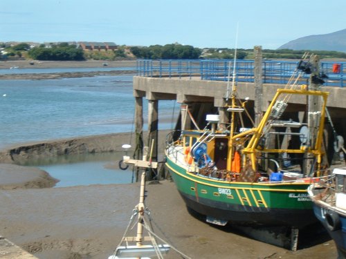 Fishing boat awaiting the tide in Walney Channel at Barrow in Furness, Cumbria.