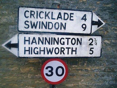 Ageing direction sign in the Thames-side village of Castle Eaton, Wiltshire