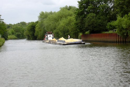 Workboat and barges entering the lock cut past the Boat Inn