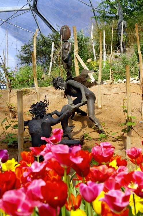 Bronze statues and flowers.