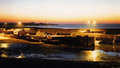 Seahouses Harbour at night looking North to Bamburgh Castle