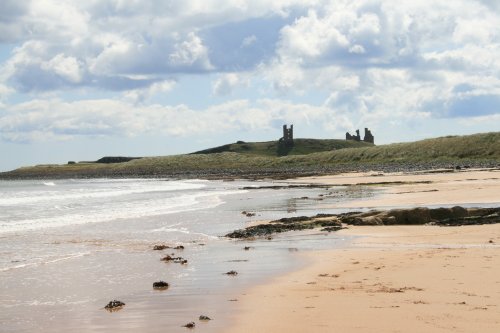 A view of Dunstanburgh Castle from the beach