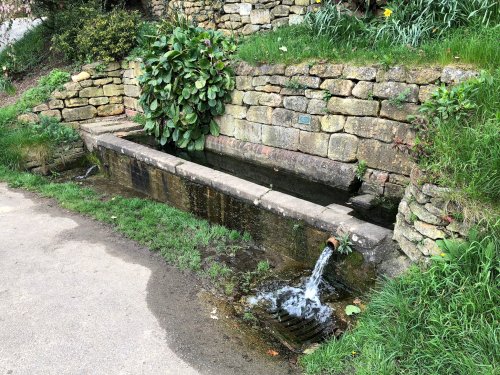 Ebrington, Fresh water stone drinking trough in centre of the village fed by natural springs. April 2018