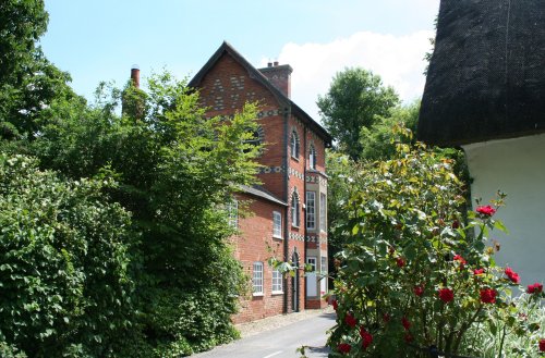 A rather unusual three-storey house built of brick in Woolstone which has rumours of spying!
