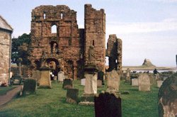 The ruins of Lindisfarne Abbey with Lindisfarne Castle in the distance. Wallpaper