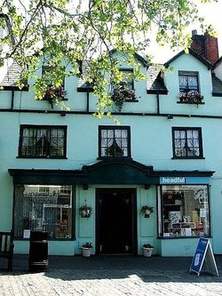 Hairdressers at Bridport Dorset, a charming turquoise building in the square