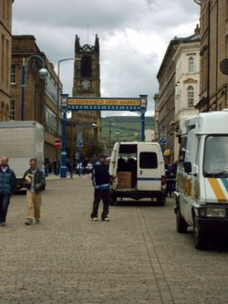 Market traders vehicles outside The Open Market, Huddersfield.