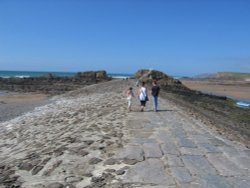 Walking along the breakwater Wallpaper
