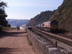 A freight train trundles along the sea wall at Teignmouth, Devon in September 2002. Wallpaper