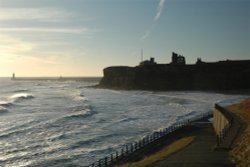 Tynemouth Castle and Priory, and North Pier with South Pier behind.