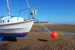 The harbour at Wells-next-the-Sea at low tide. RNLI lifeboat house in the distance. Wallpaper