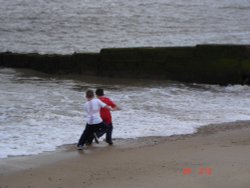 Felixstowe, Suffolk. Kids playing with the waves.. Wallpaper