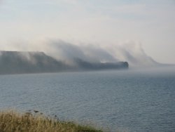 Sea mist rises over Sandsend Ness, Whitby, North yorks Wallpaper