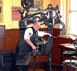 Printer at work in early 20th century dress , Beamish Museum 2006