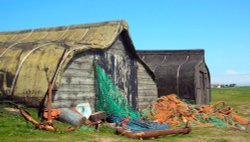 Old fishing boats converted into huts on Holy Island, Northumberland. Wallpaper