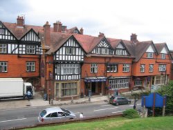 The Crown Hotel which is opposite Saint Michael and All Angels church, in Lyndhurst, Hampshire Wallpaper