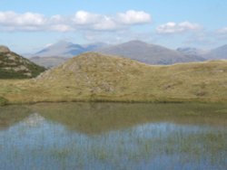 Stickle Tarn set high up on Stickle Pike near Ulpha, Duddon valley.  Scafells in the background.
