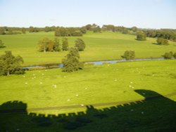 Shadow of Alnwick Castle looking down over the valley. Northumberland