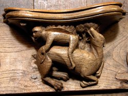 Norwich Cathedral misericord - Ape riding a dog. Norwich, Norfolk. Wallpaper