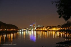 London Putney at night seen from the towpath on the Barnes side of the River Thames.