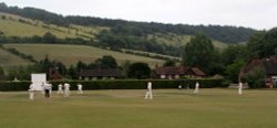 Cricket game with Box Hill in the background in Dorking, Surrey July 2006