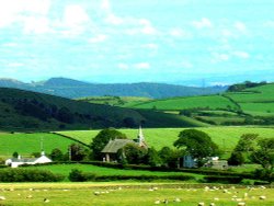 The Countryside a couple minutes away from Ulverston, Cumbria, looking onto a church and houses.
