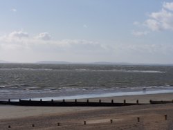 A view looking to the Isle of Wight from the beach next to bill house. Selsey, West Sussex
