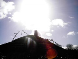 Glastonbury tor with the winter sun above it