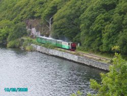 The train going round the lake at Llanberis North Wales this was taken from the boat on the lake.
