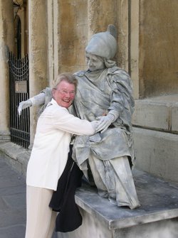 Street entertainer with tourist in Bath, Somerset