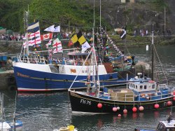 Bunting decorates the boats in Mevagissey Harbour, Cornwall Wallpaper