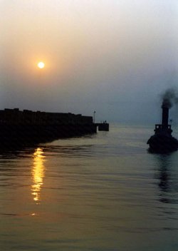 A Steam Tug Approaching Whitstable Harbour at Sunset