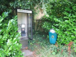 Modern phone box well hidden away in Weston on the Green