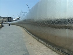 Wall of water outside train station Wallpaper