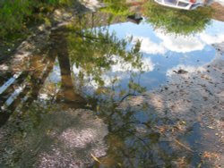 The reflection in a puddle in the car park Wallpaper