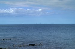 View of the wind turbines from the cliff top. Wallpaper