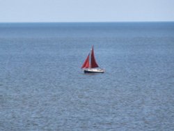 Lonely little sailing boat off Corton.