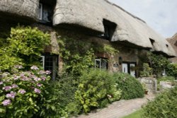 Cottage in village with  flowers and Church Wallpaper