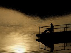 Angler in the evening at Lady Bower Reservoir, Derbyshire