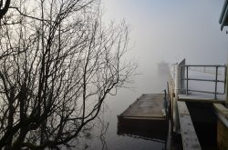 The dock of the lake shrouded in mist