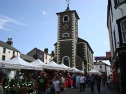 Market day in Keswick, the Moot Hall in the background. Wallpaper