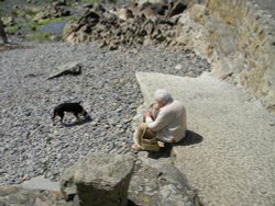 Lady resting at Port Quin Wallpaper