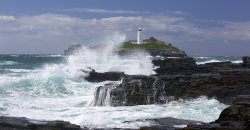 Godrevy Lighthouse and Waves on Rocks Wallpaper
