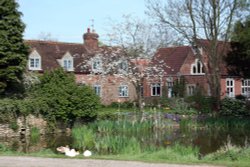 The village pond at Marsh Baldon with the village school to the right in the background